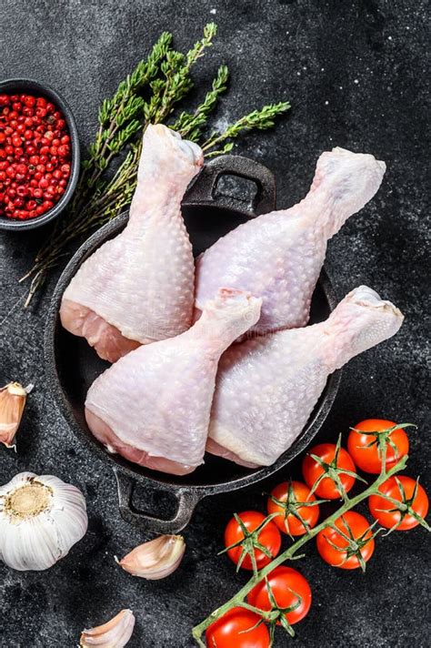 Raw Chicken Drumsticks Legs With Herbs And Spices In A Pan Organic Poultry Meat Black