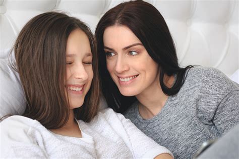 Beautiful Mother And Her Cute Daughter Talking Each Other Stock Photo