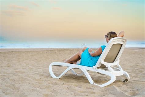 Woman Relaxing On Beach Sitting On Sunbed Stock Image Image Of Aged