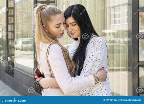Two Women Hugging On A City Street Stock Image Image Of Blonde Closed 149931257
