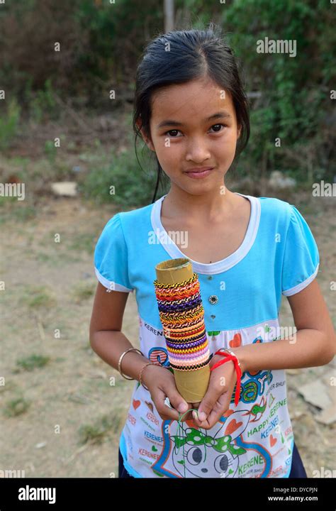 Young Cambodian Girl Offers Her Woven Bracelets And Ringsjewelry For