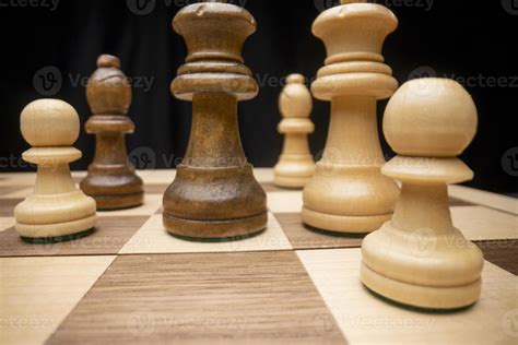 A Chess Board Asnd Pieces Against Black Background Stock Photo