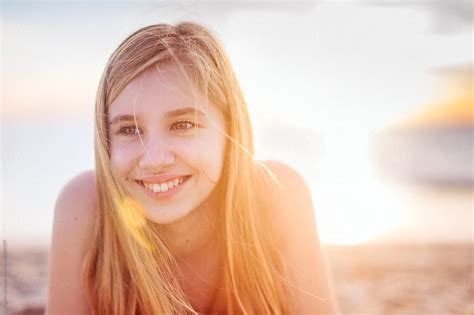 Smiling Teenage Girl At Sunset By Angela Lumsden