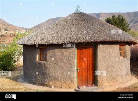 Traditional African Round Clay House With Thatched Roof In Village