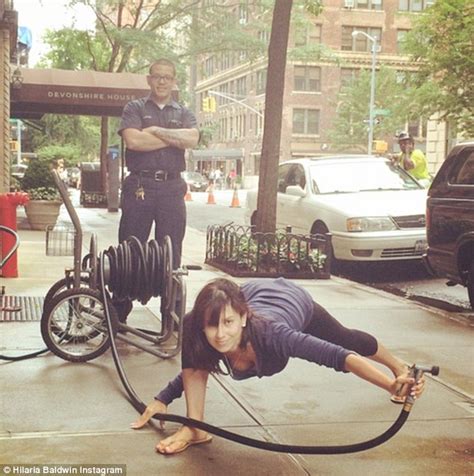 Hilaria Baldwin Shows Off Cleavage While Holding Water Hose In Bizarre