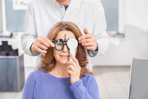 Doctor Examining Eyesight Patient With Test Glasses
