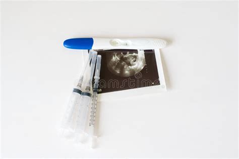 Ultrasound Scan Of Baby And Pregnancy Test On White Background Stock