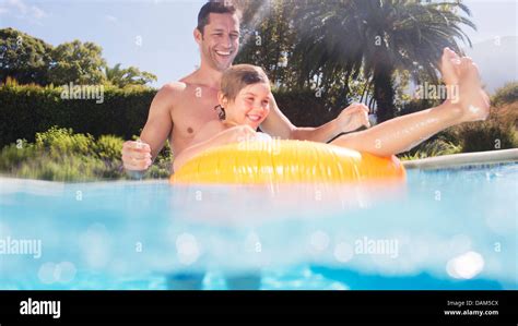 Father And Son Playing In Swimming Pool Stock Photo Alamy