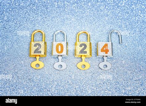 Unlocking the new year 2024: Row of four labeled padlocks with master