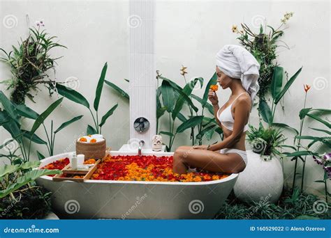 Woman Relaxing In Outdoor Bath With Flowers In Bali Spa Hotel Stock Photo Image Of Organic
