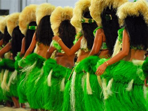 Group Of Polynesian Dancers In Traditional Green Dresses Performing In