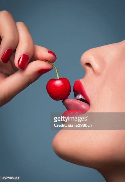 Woman Licking Cherry Photos And Premium High Res Pictures Getty Images