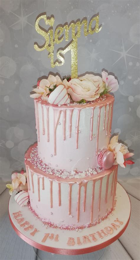 1st birthday 2 tier drip cake with dipped strawberrys artifitial flowers and macarons 18th