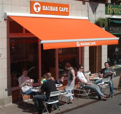 You will be able to use your outdoor spaces and expand your business. Foldiing Arm Awnings, cafe tables, menu | Fabric awning ...