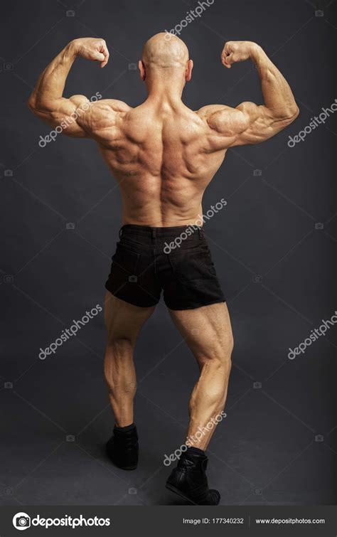 Athlete In Back Double Biceps Pose Bodybuilder Showing Muscles On