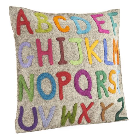 A Decorative Pillow With Alphabets On The Front And Back Made Out Of Felt