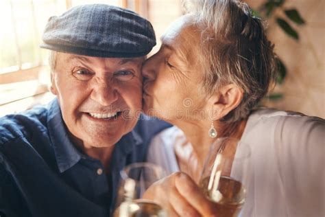 love toast and old couple kiss with champagne in celebration of a happy marriage anniversary