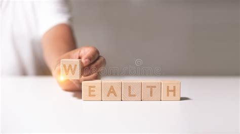 Wealth Text Written On Wooden Cubes With Stacked Coins Growth And