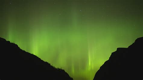 Northern Lights Behind Two Mountains Free Stock Video