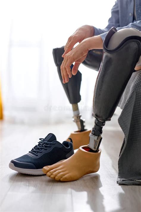 Man Leg Amputee Wearing Sneakers On Prosthesis At Home Sitting On Bed