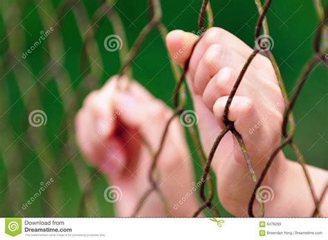 Behind Fence I An Image Of A Person Under Restriction Sponsored
