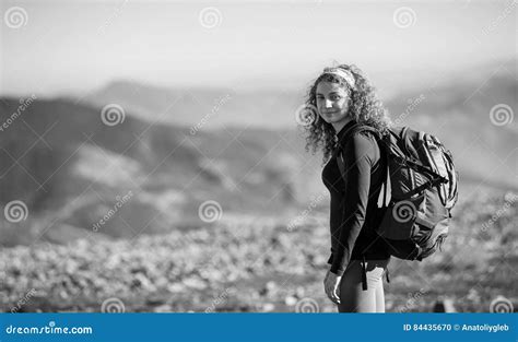 Woman Enjoying Nature On Backpacking Trip In The Mountains Stock Photo