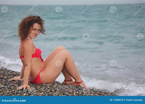 Beauty Girl Sits On Pebble Beach Stock Photo Image Of Girl Outside
