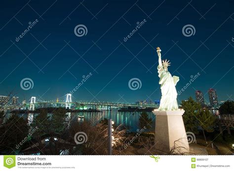 Liberty Statue At Odaiba With Rainbow Bridge In Background