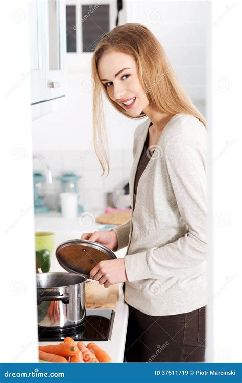 beautiful caucasian woman standing in kitchen and cooking stock image image of cook adult