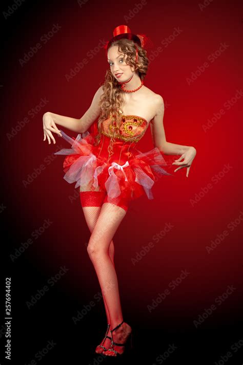 Sexy Burlesque Dancer Stripper Posing In Red Corset And Red Hat With