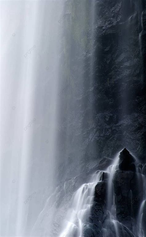 Captivating Waterfall Motion Over Rocky Terrain In A Dramatic Blur