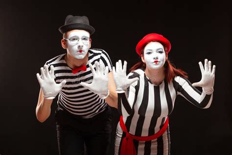 Portrait Of Man And Woman Mime Artists Performing Isolated On Black