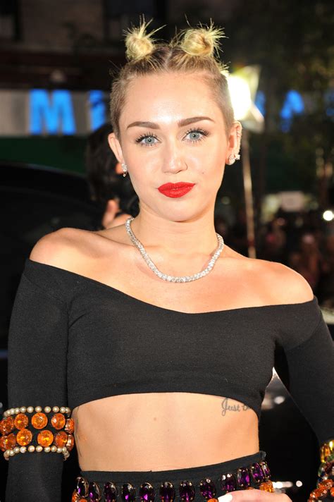miley cyrus pulled her hair up into a double top knot look with her see all the gorgeous and