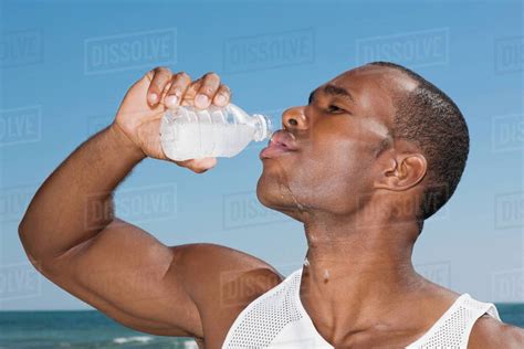 African Man Drinking Water Bottle Stock Photo Dissolve