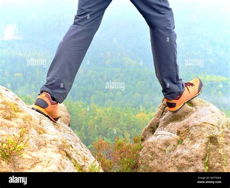Hiker Legs In Comfortable Trekking Boots Stand On Rocky Peak Man Legs