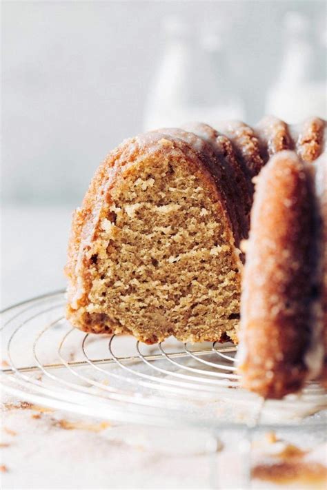 A Bundt Cake On A Wire Rack With One Slice Cut Out And Ready To Be Eaten