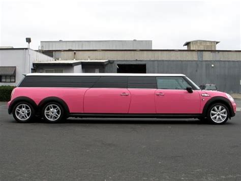A Pink And Black Limousine Parked In A Parking Lot