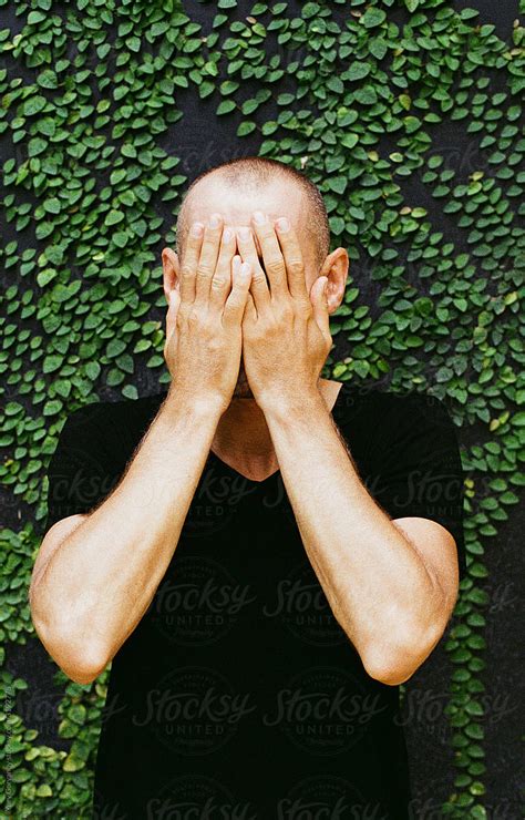 Portrait Of A Guy Covering His Face With His Hands By Stocksy Contributor Yury Goryanoy