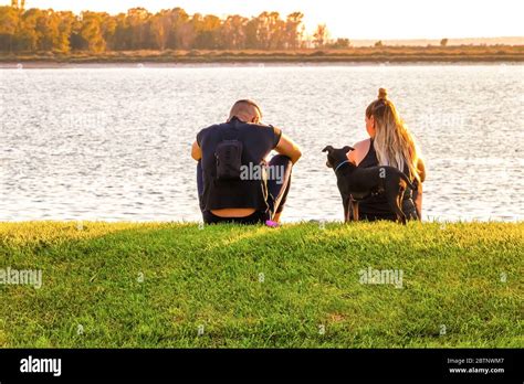 Beautiful Lovers Sitting On Grass Hi Res Stock Photography And Images