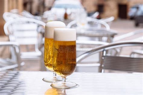 Ice Cold Beers Pouring Into Glasses On Table Stock Photo Image Of