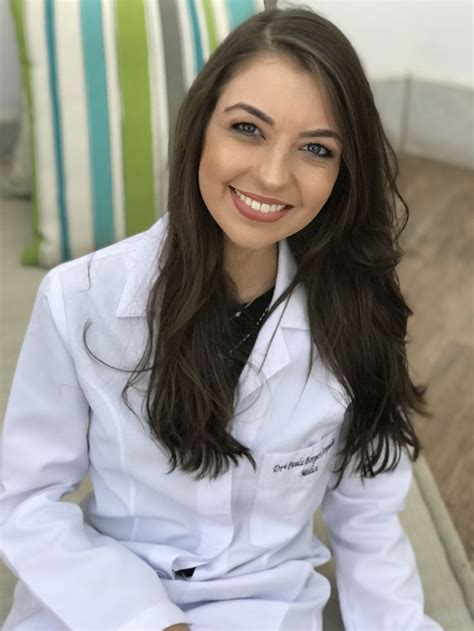 a woman in white lab coat sitting down