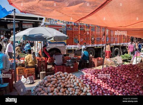 Vendors Selling Vegetables In A Crowded Wholesale Market Stock Photo
