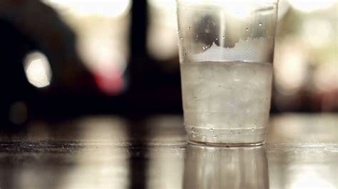 Ice Cold Water In Plastic Cup On Table Stock Footage Sbv 301105719