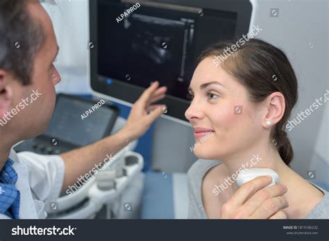 Doctor Performing Neck Ultrasound Examination On Stock Photo 1819186232