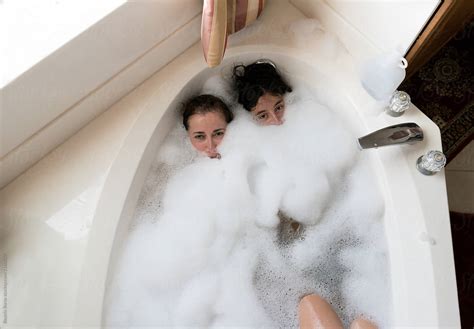 Overhead Photo Of A Mother And Her Teenager Babe In The Bathtub By Stocksy Contributor