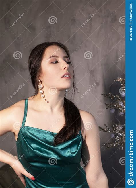 Attractive Brunette Woman In Elegant Green Aquamarine Dress In A Loft Cafe Beautiful Sensual