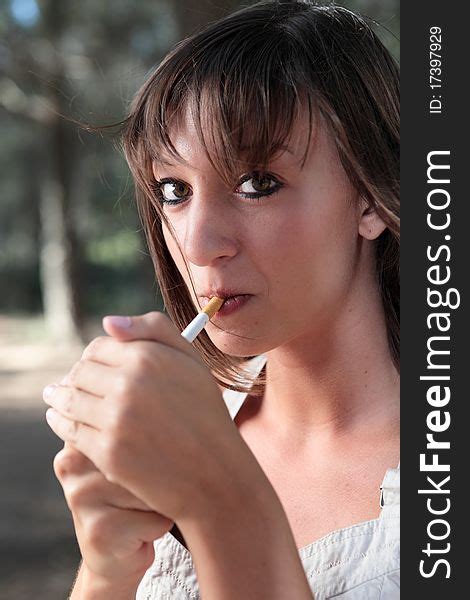 Portrait Of Young Woman Lighting A Cigarette Free Stock Images