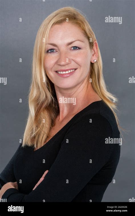 Studio Portrait Headshot Of Attractive Happy Smiling Middle Aged Blonde Woman In Her Thirties Or