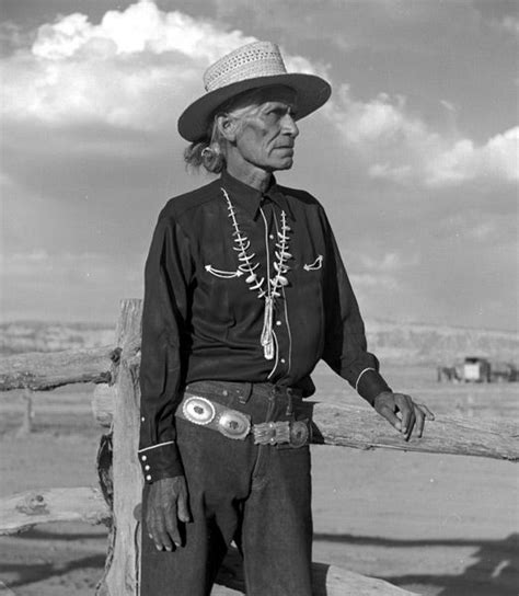 A Navajo Man With His Hair Tied Into A Traditional Bun Or Tsiiyéél
