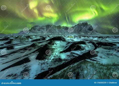 A Beautiful Green And Red Aurora Dancing Over The Vestrahorn Iceland